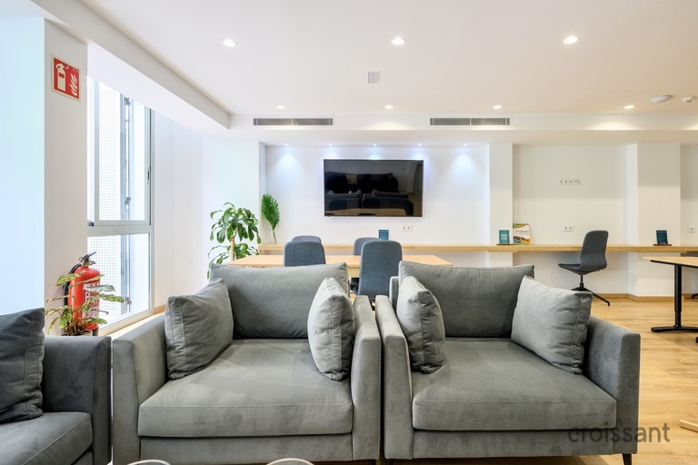 a living room filled with furniture and a flat screen tv