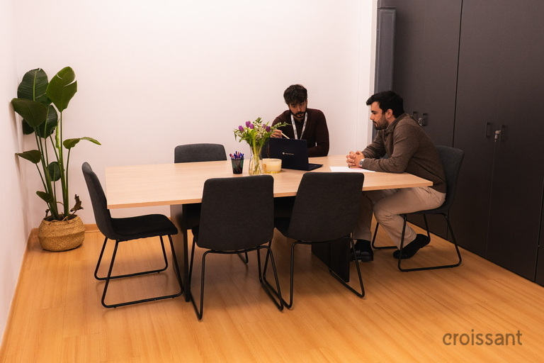 a person sitting at a table in a room