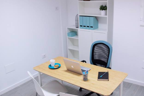 a desk with a computer on a table