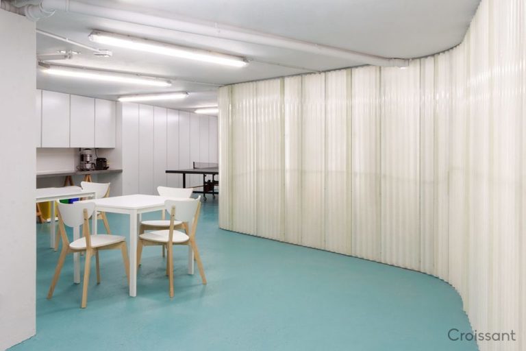 a bedroom with a bed and a chair in a room