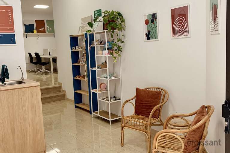 a living room filled with furniture and a refrigerator
