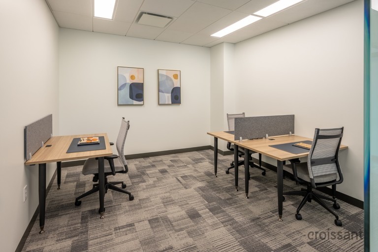 an office with a desk and chair in a room