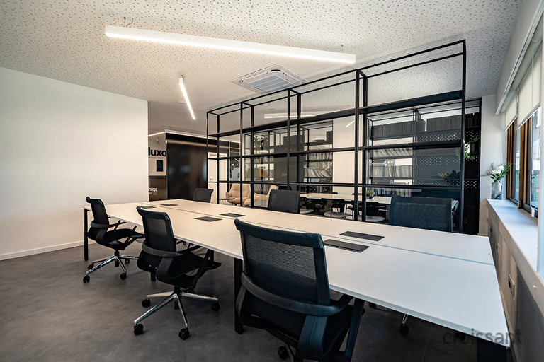 an office with a desk and chair in a room