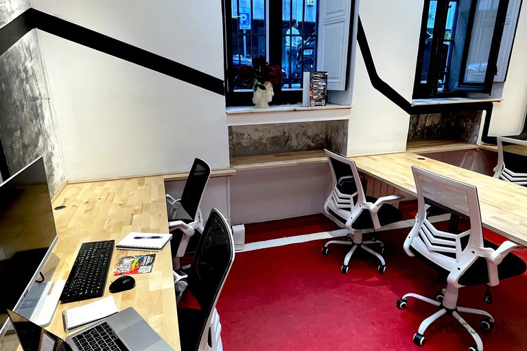 a desk with a laptop computer sitting on top of a table