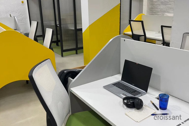 a desk with a laptop computer sitting on top of a table