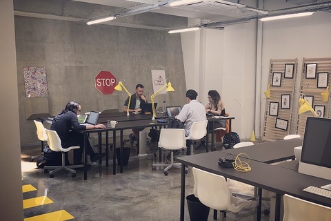 a group of people sitting at a table in a room