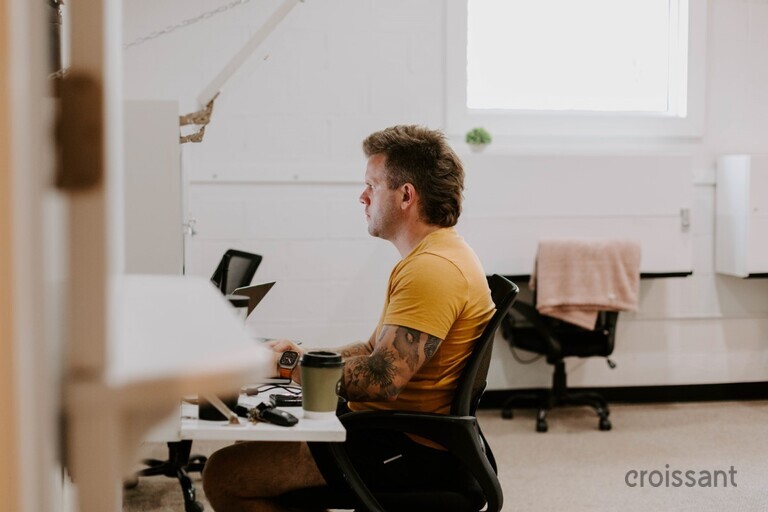 a man standing in front of a computer