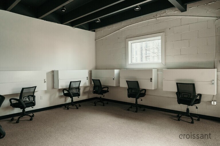 a bedroom with a bed and desk in a room