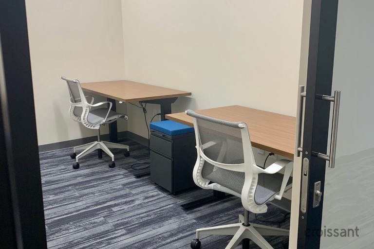 a bedroom with a bed and a chair in a room