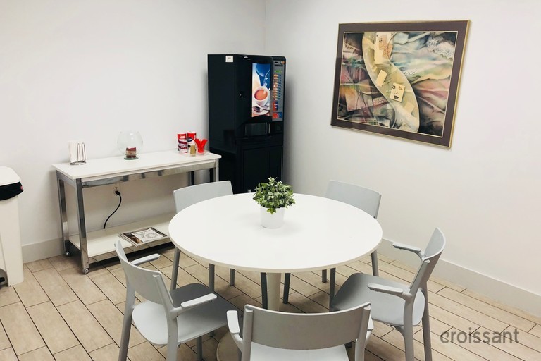 a person sitting at a table in front of a mirror