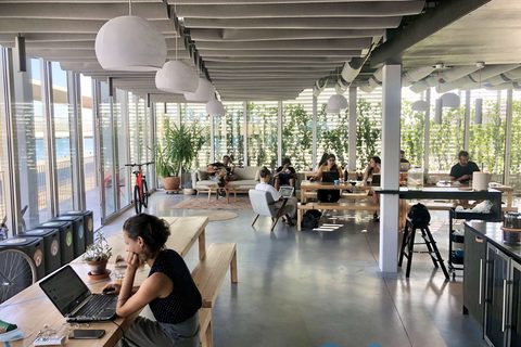 a group of people sitting at a table in front of a window
