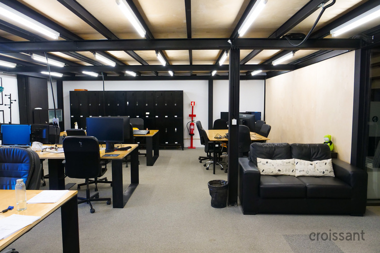 a room filled with furniture and a large screen