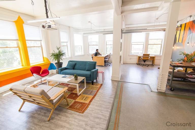 a living room filled with furniture and a large window
