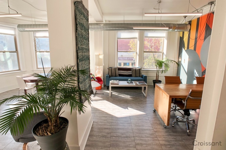 a living room filled with furniture and a large window