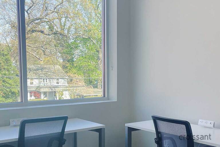 a bedroom with a desk and chair in a room