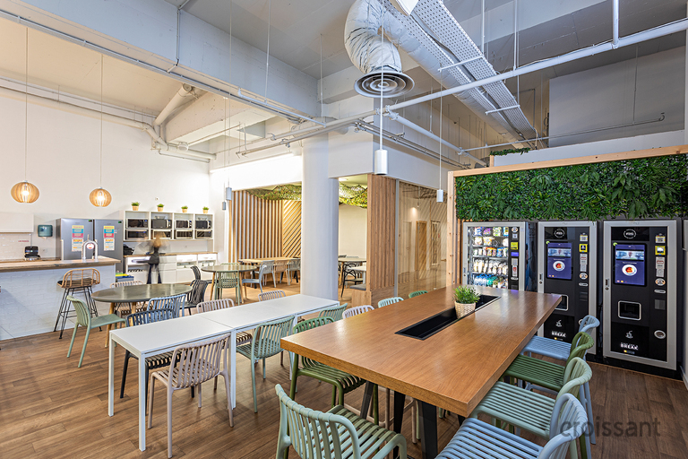 a kitchen with a table and chairs in a room