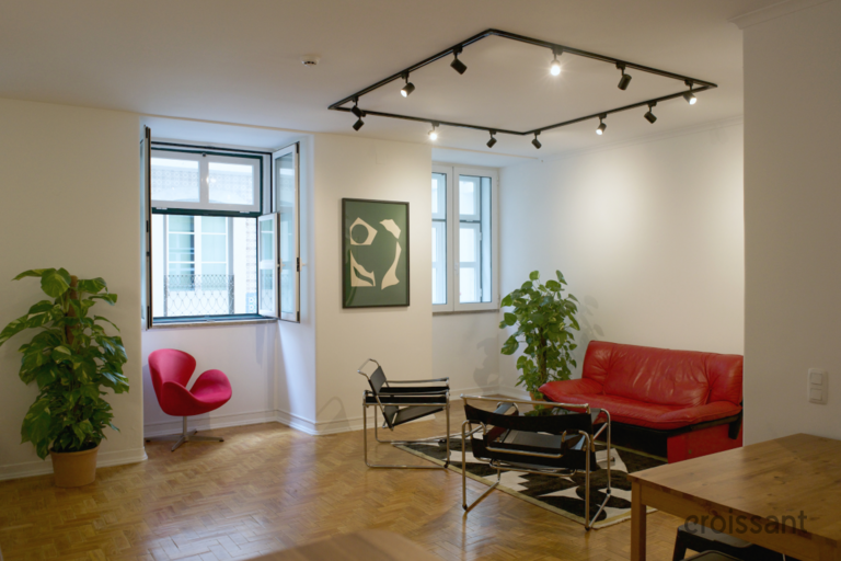 a living room filled with furniture and a large window