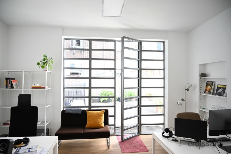 a living room filled with furniture and a large window