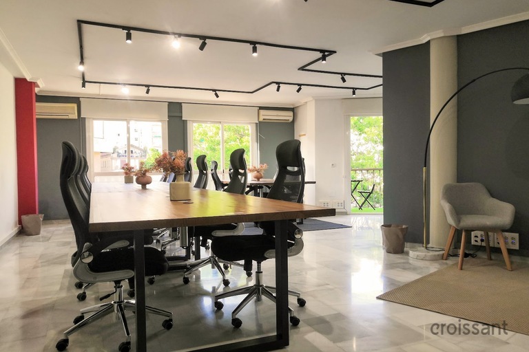 a living room filled with furniture and a large window