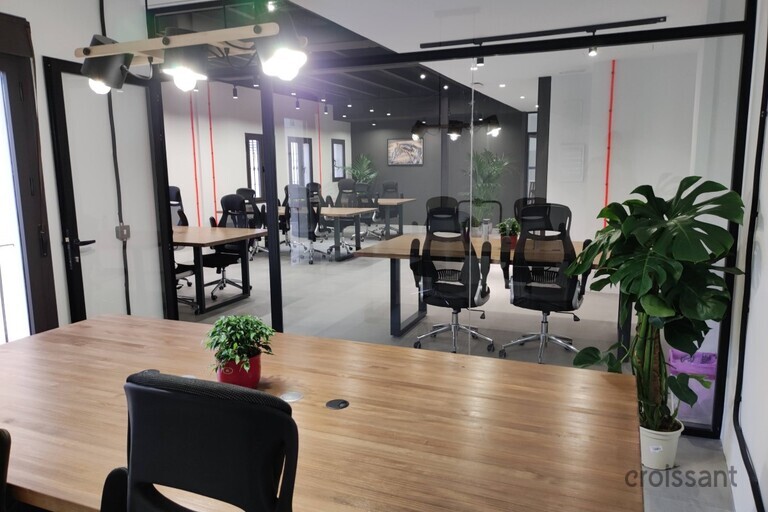 a view of a living room filled with furniture and a large window