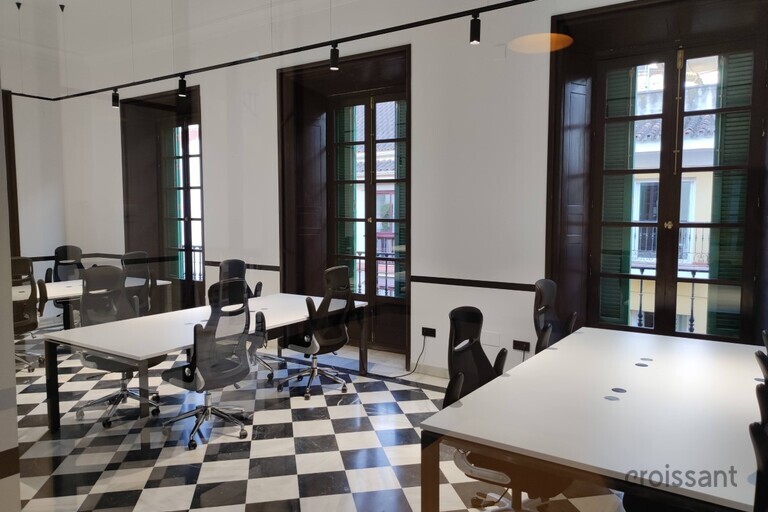 a room filled with furniture and a large window