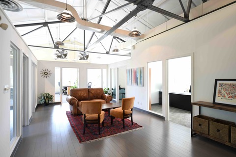 a living room filled with furniture and a large window