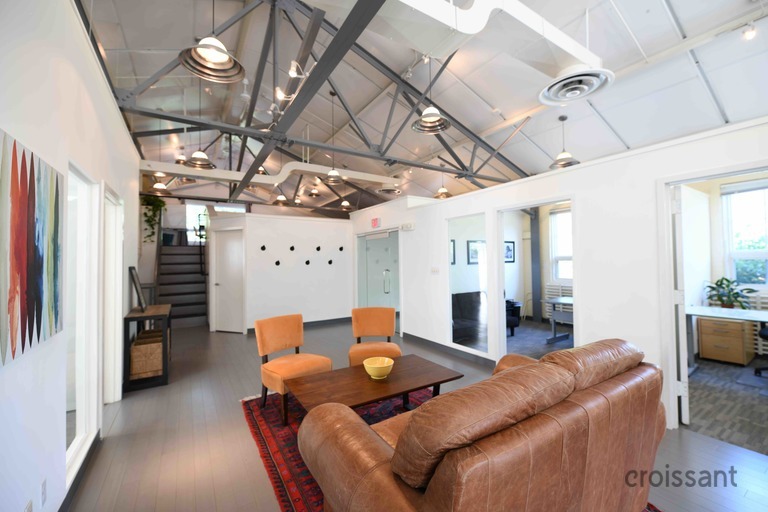 a living room filled with furniture and a large window