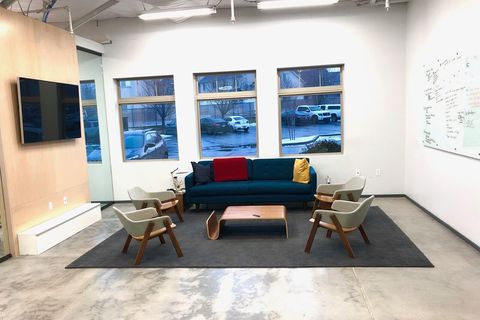 a living room filled with furniture and a large window