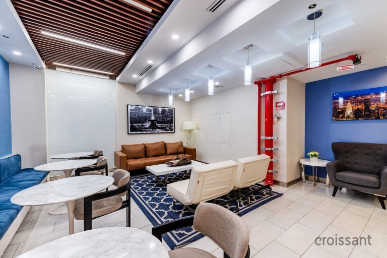 a living room filled with furniture and a large window