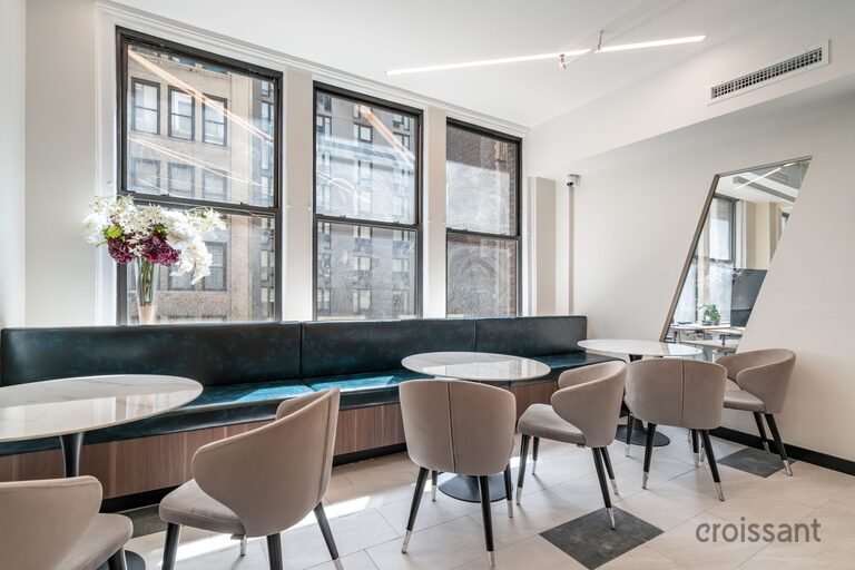 a living room filled with furniture and a large window