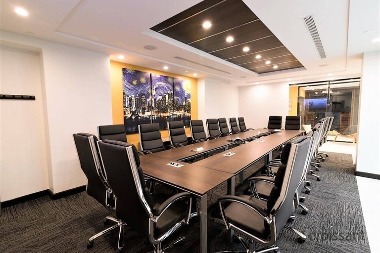a kitchen area with a desk and chair in a room