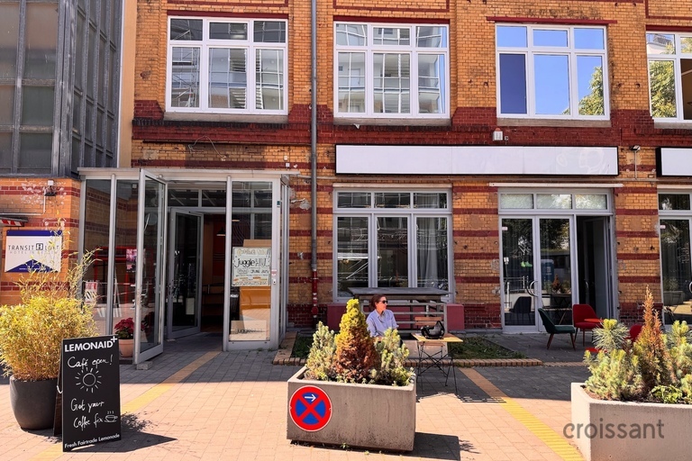 a bench in front of a brick building