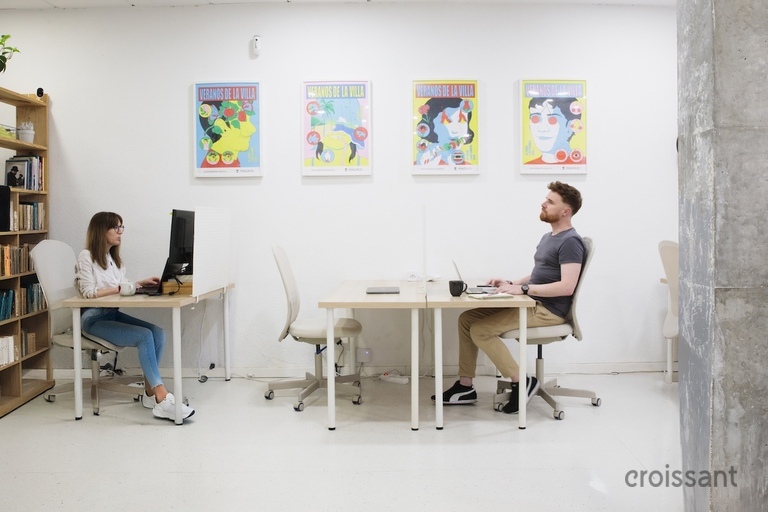 a man sitting at a desk in front of a building