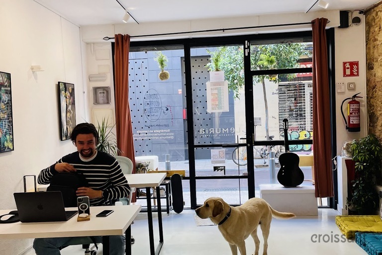 a group of people in a living room with a dog