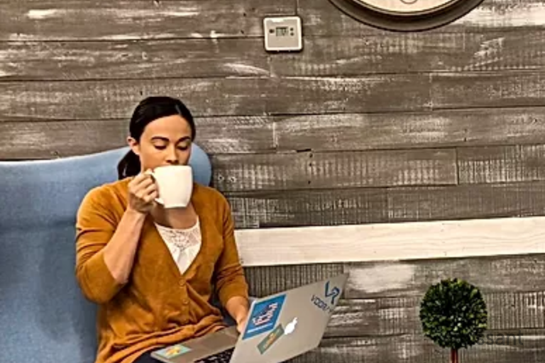 a person sitting in a chair talking on a cell phone
