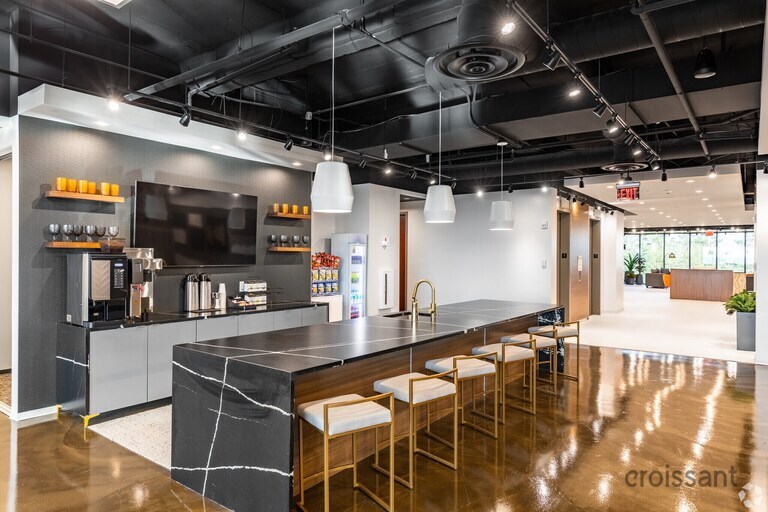 a large commercial kitchen with stainless steel appliances