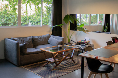 a living room filled with furniture and a large window