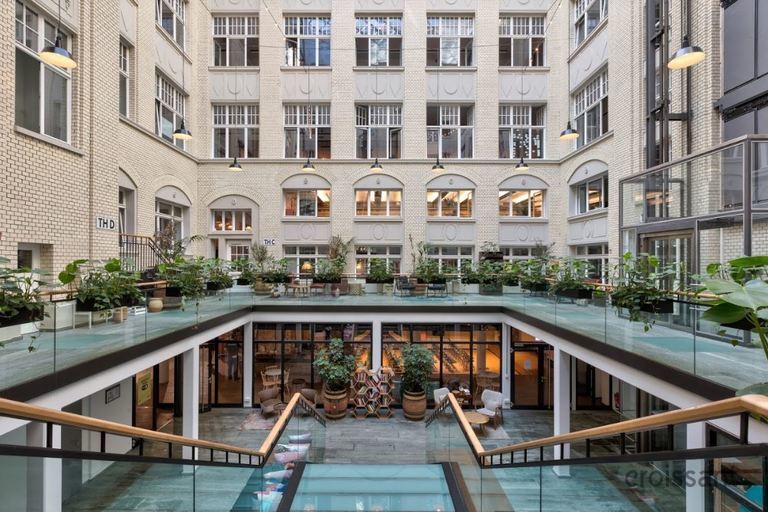 a group of people sitting at a table in front of a building