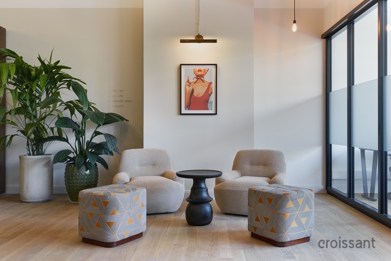 a living room filled with furniture and vase on a table