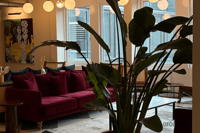 a room filled with furniture and vase of flowers on a table