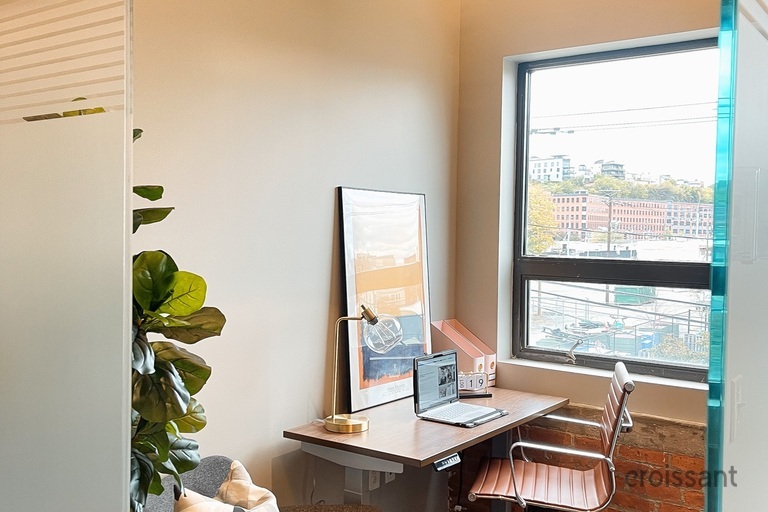 a room filled with furniture and a large window