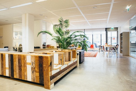 a room filled with furniture next to a building