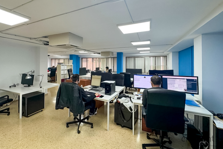 an office with a desk and chair in a room