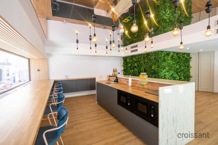 a kitchen with a table and chairs