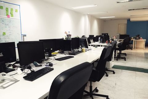an office with a desk and chair in a room