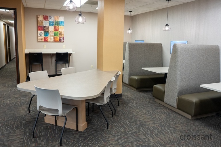 an office with a desk and chair in a room