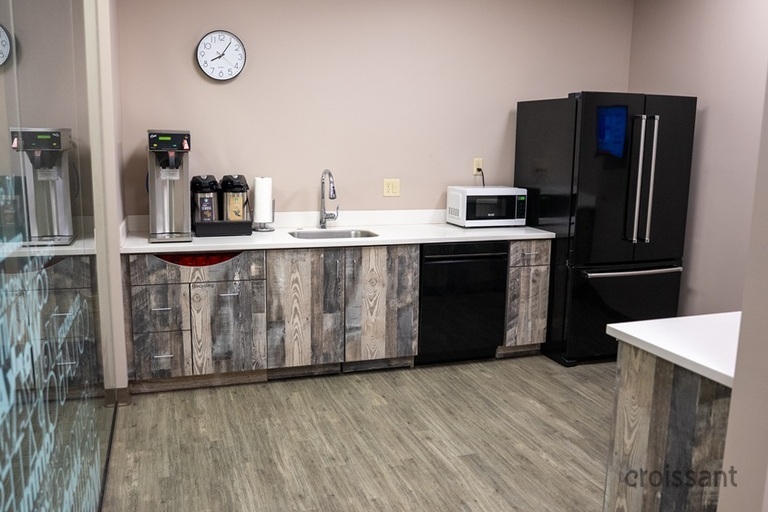 a large kitchen with stainless steel appliances and wooden cabinets