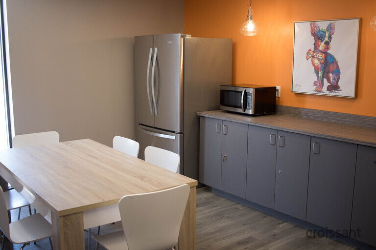 a bedroom with a bed and desk in a room