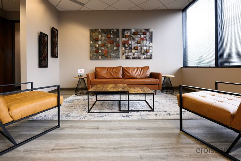 a living room filled with furniture and a large window