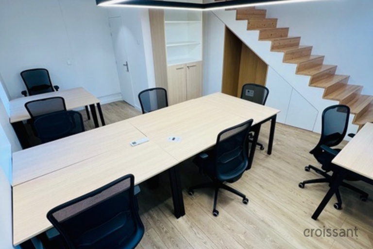 an office with a desk and chair in a room
